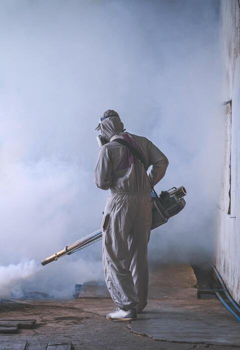 Pest control technician providing service